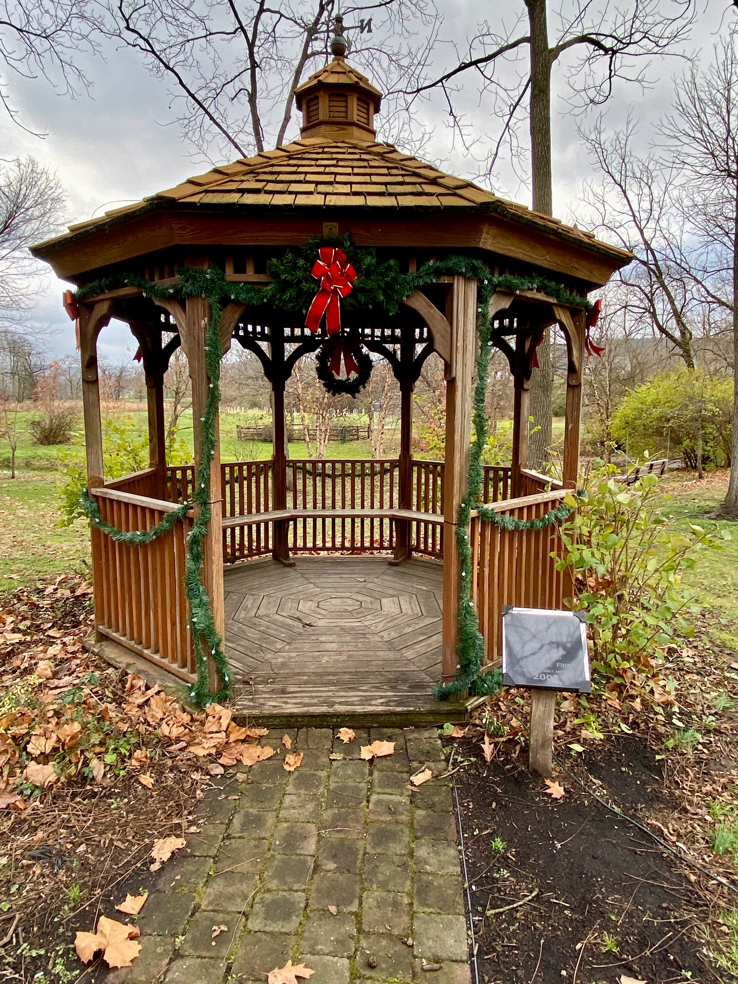Gazebo at Poole Forge decorated with holiday garland and red bows for the Christmas season